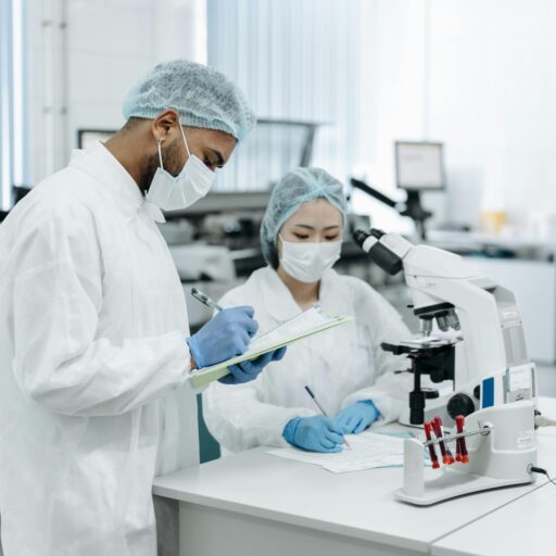Two scientists collaborating on research in a modern laboratory setting, using advanced equipment.
